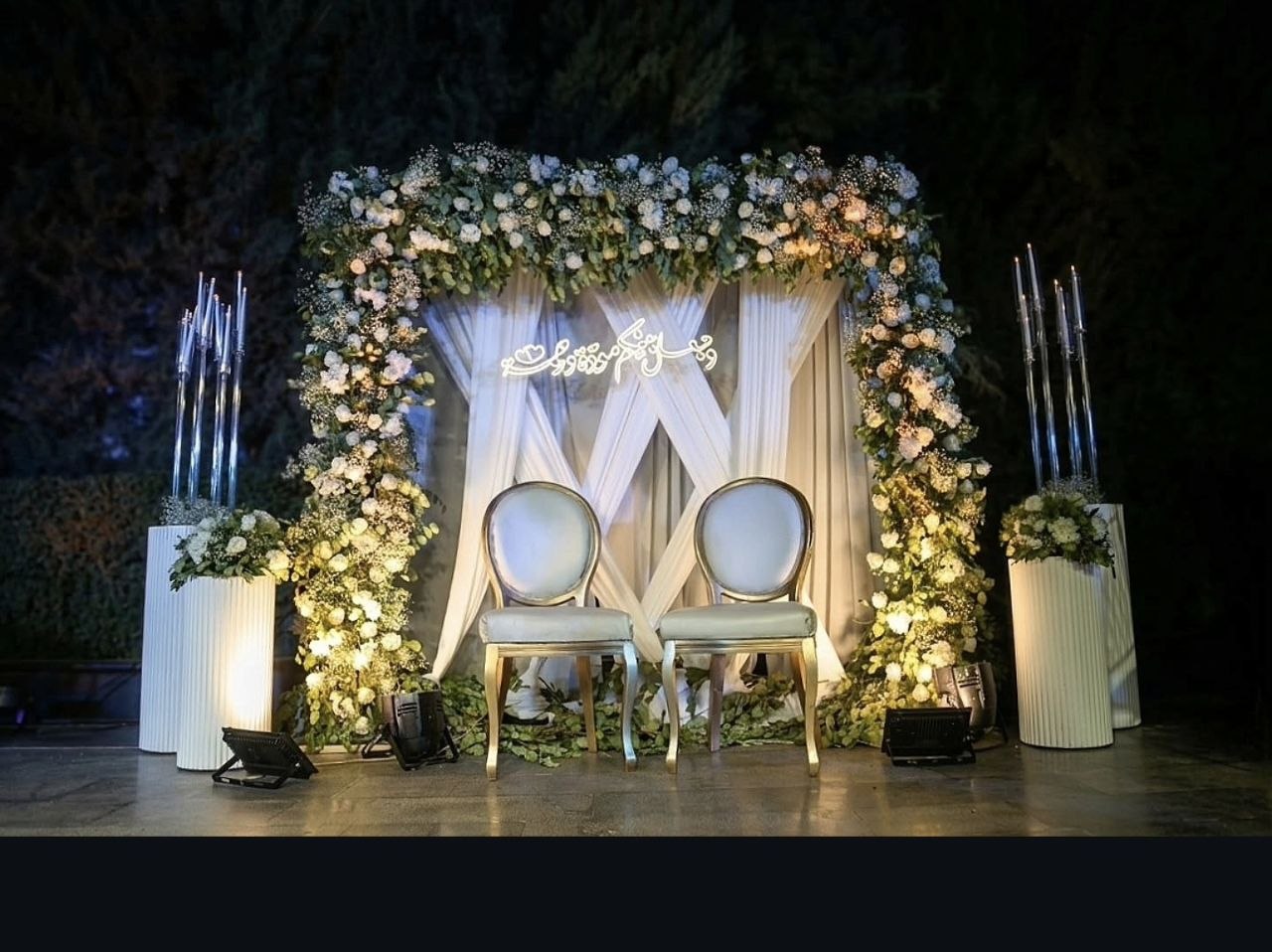 Wedding ceremony stage with family and musicians